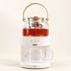 Automatic Steam Tea Brewer — 220V on a warm ivory studio background