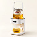 Automatic Steam Tea Maker on a warm ivory studio background