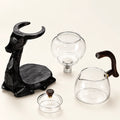 Black Elk Glass Tea Set on a warm ivory studio background