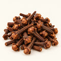 Cloves — 50g on a warm ivory studio background