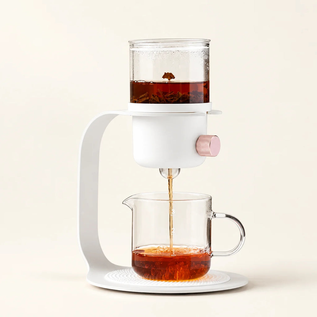 Flow Tower Tea Brewer on a warm ivory studio background