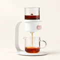 Flow Tower Tea Brewer on a warm ivory studio background