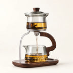 Glass Gongfu Tea Brewer on a warm ivory studio background
