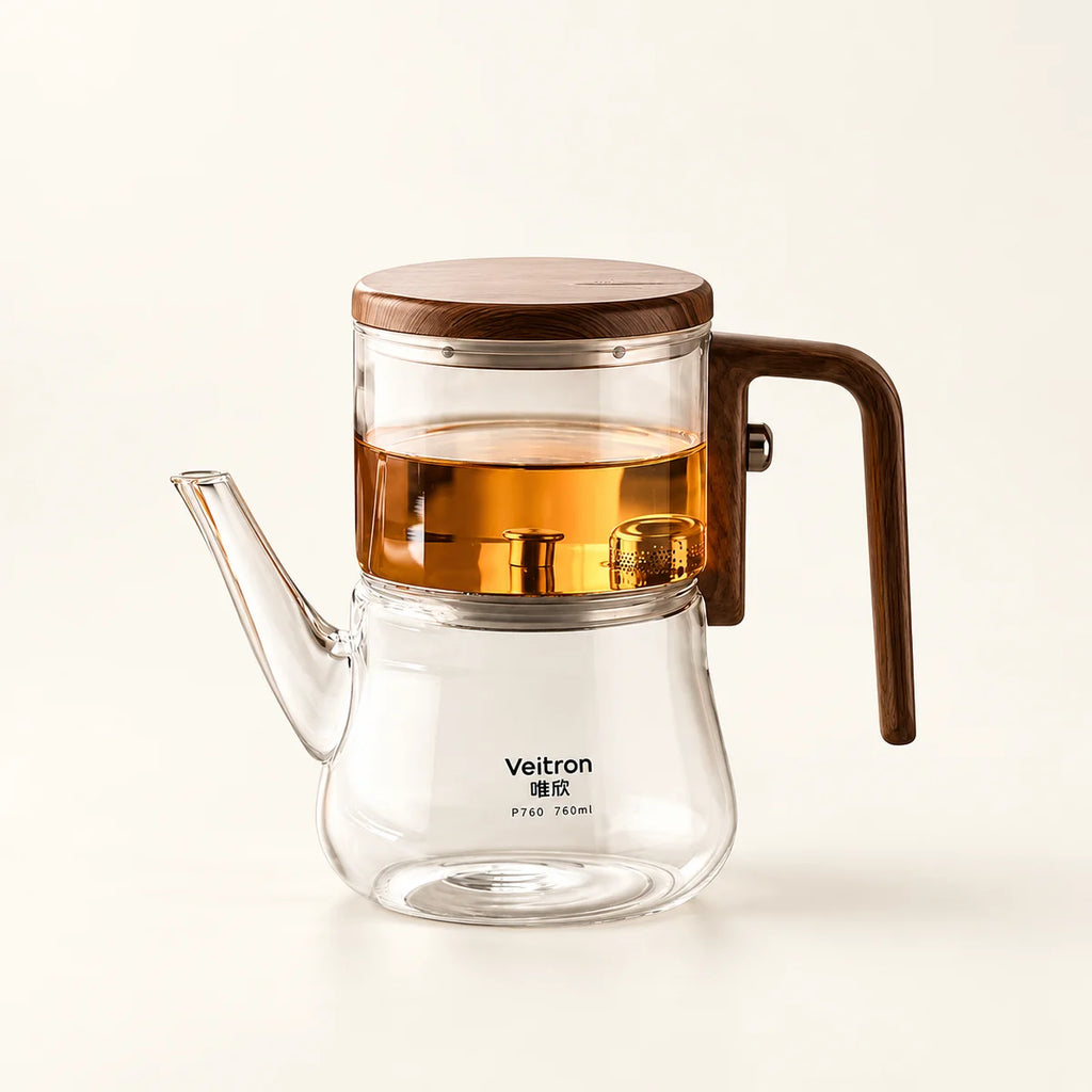 Glass Infuser Teapot with Wood Handle on a warm ivory studio background