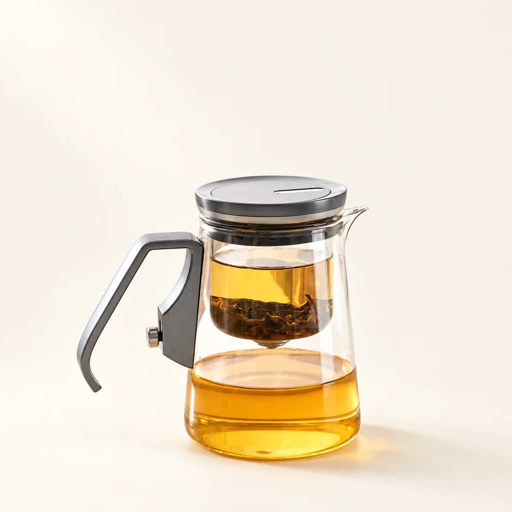 Glass Tea Brewer with Magnetic Filter on a warm ivory studio background