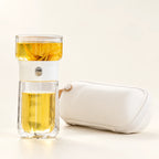 Glass Tea Infuser Bottle — Black / White on a warm ivory studio background