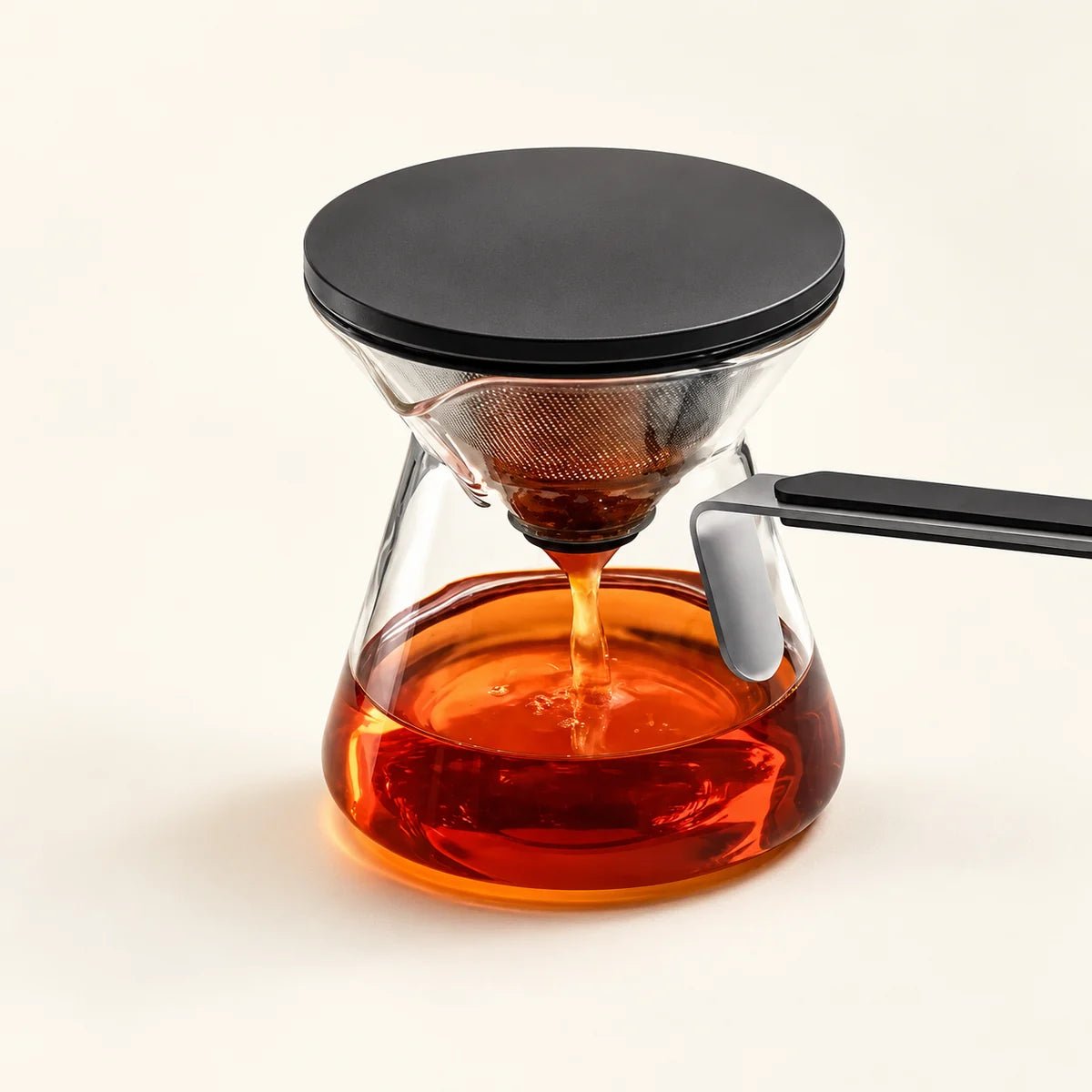 Glass Tea Infuser Pot on a warm ivory studio background