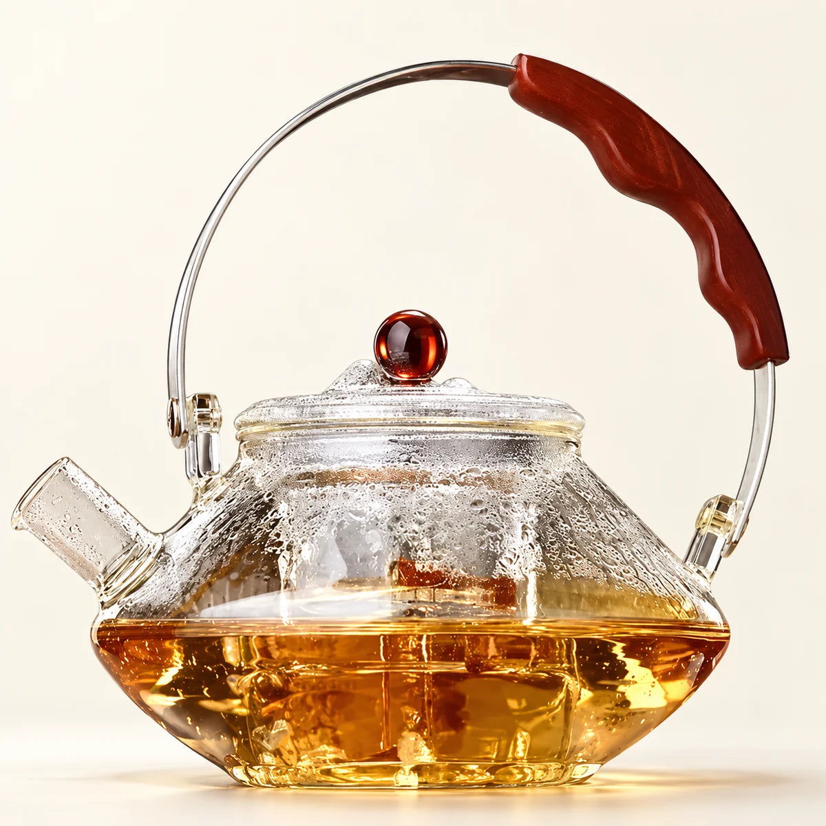 Glass Tea Kettle — 1000ml on a warm ivory studio background