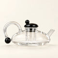 Glass Teapot Set — 600ml, 2 Cups on a warm ivory studio background
