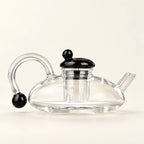 Glass Teapot Set — 600ml, 2 Cups on a warm ivory studio background