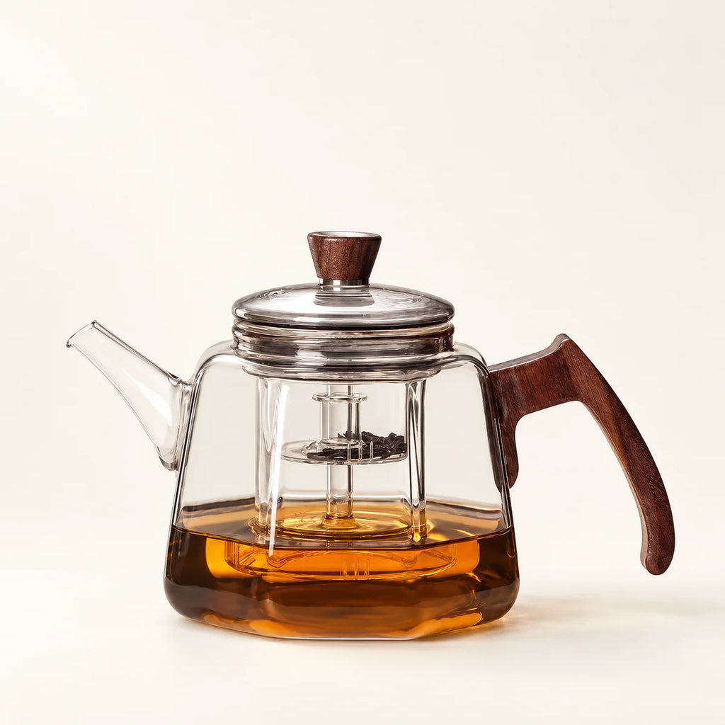 Heat-Resistant Glass Tea Kettle on a warm ivory studio background
