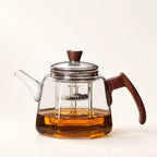 Heat-Resistant Glass Tea Kettle on a warm ivory studio background