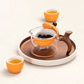 Justice Glass Tea Infuser on a warm ivory studio background