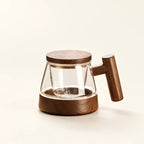Magnetic Glass Teapot with Wood Handle on a warm ivory studio background