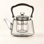 Octagonal Glass Tea Kettle on a warm ivory studio background