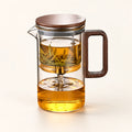 Press-Lid Glass Infuser Teapot on a warm ivory studio background